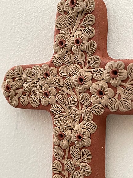 Detail view of the decorative foliage carved into the cross.