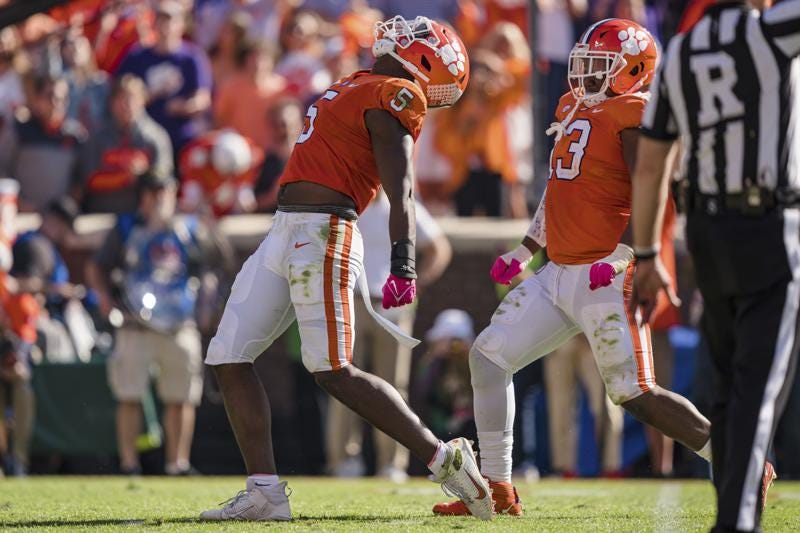 Clemson defensive end K.J. Henry (5) celebrates after making a sack in the second half during an NCAA college football game against Syracuse on Saturday, Oct. 22, 2022, in Clemson, S.C. (AP Photo/Jacob Kupferman)