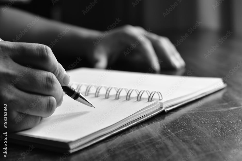 Man hand with pen writing on notebook. black and white. Stock Photo | Adobe  Stock