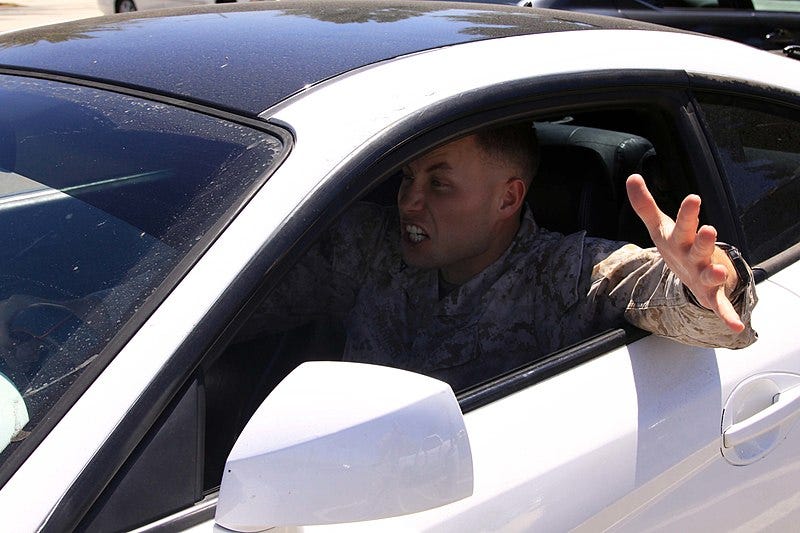 A man in a white car experiences road rage