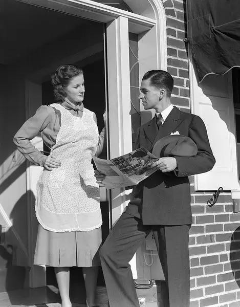 Salesman At Door Of A House Wife Showing Her A Bro (Photos Framed,  Prints,...) #11928850