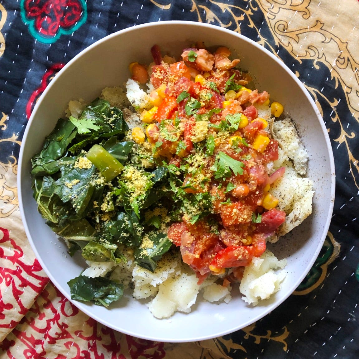 quick spicy bean and potato bowl recipe in a grey bowl on a colorful background.