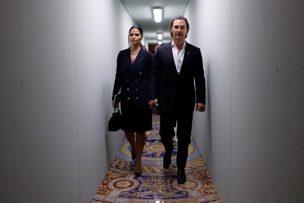 Actor Matthew McConaughey and his wife Camila Alves McConaughey walk between meetings with lawmakers.