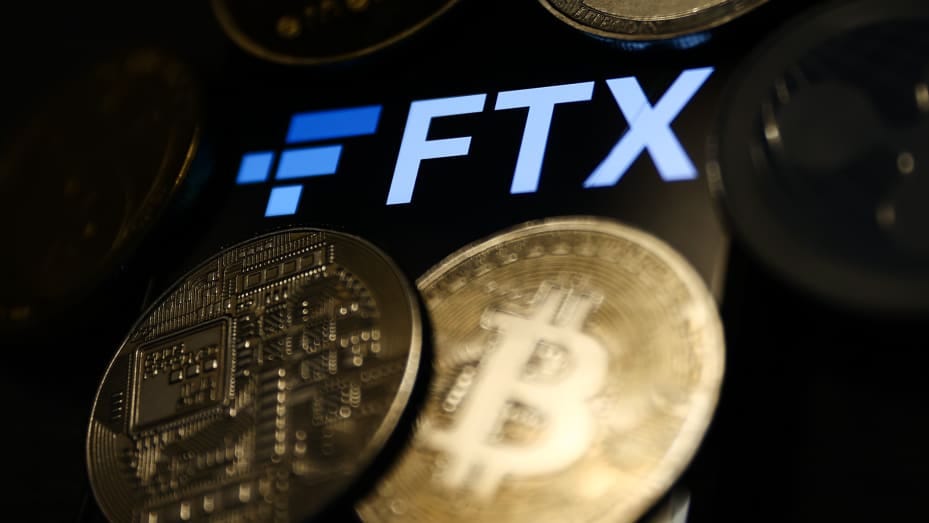 FTX logo displayed on a phone screen and representation of cryptocurrencies are seen in this illustration photo taken in Krakow, Poland on November 14, 2022. (Photo by /NurPhoto via Getty Images)