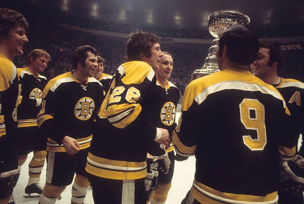 Boston Bruins Phil Esposito , Don Awrey and John Bucyk victorious with Stanley Cup after winning game and series vs New York Rangers at Madison...