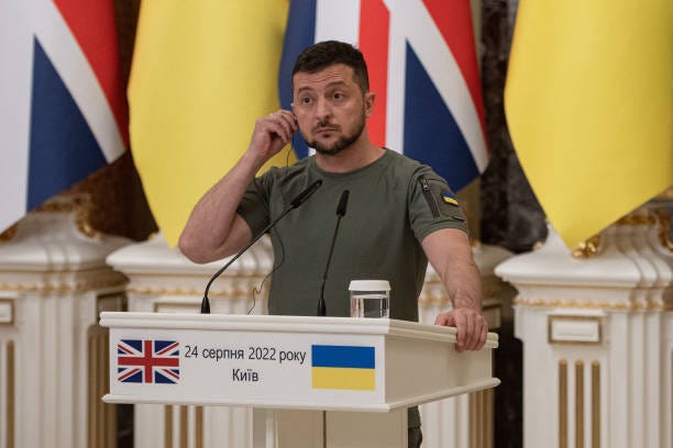 Ukrainian President Volodymyr Zelensky listens as he and British Prime Minister Boris Johnson give a press conference on August 24, 2022 in Kyiv,...