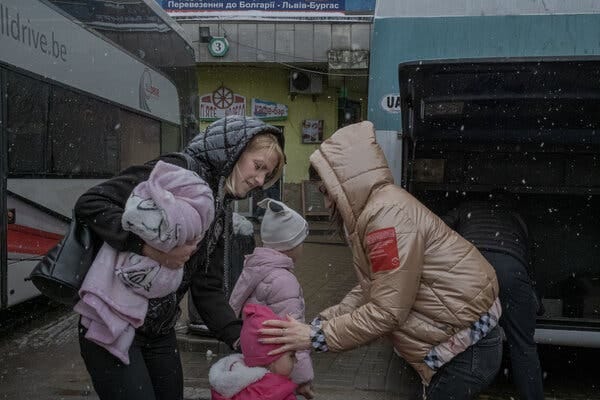 Homecoming: Mariia Seniuk, left, with her two daughters, arriving from Szczecin, Poland, at the main bus terminal in Lviv, Ukraine. “Home is home,” she said.