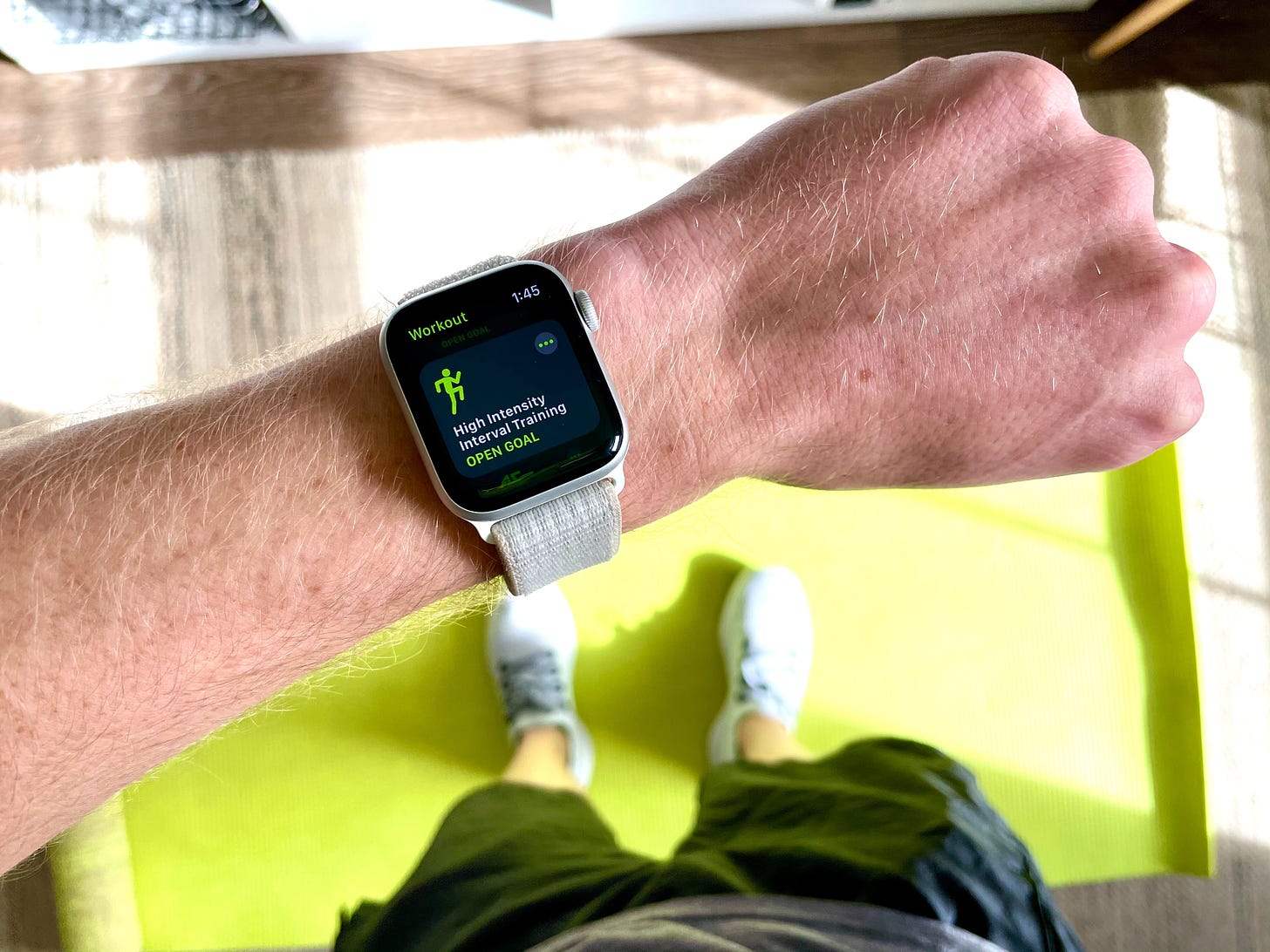 Apple Watch on wrist with workout displayed