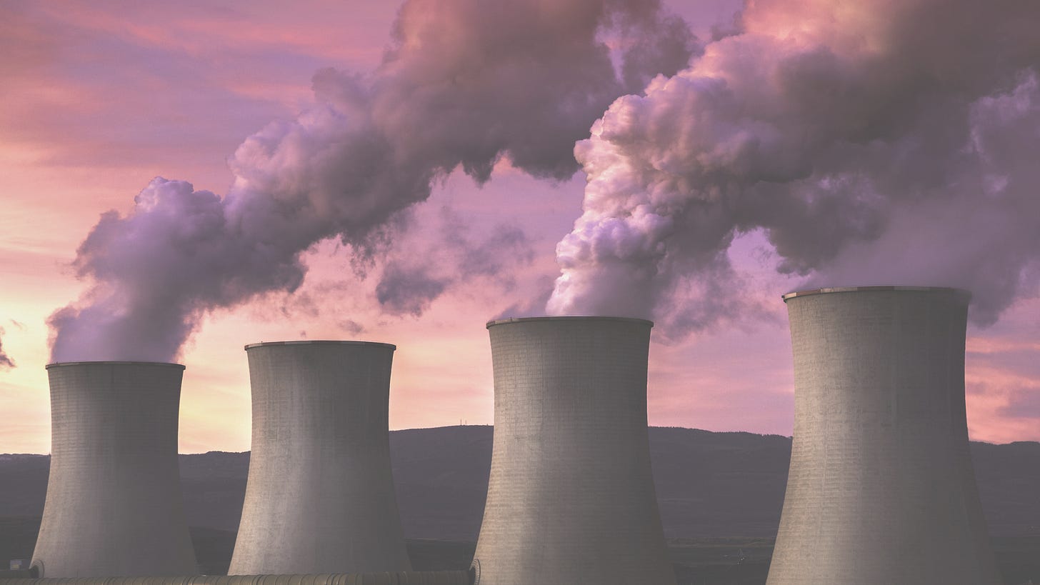 smoke rising from four thick smokestacks