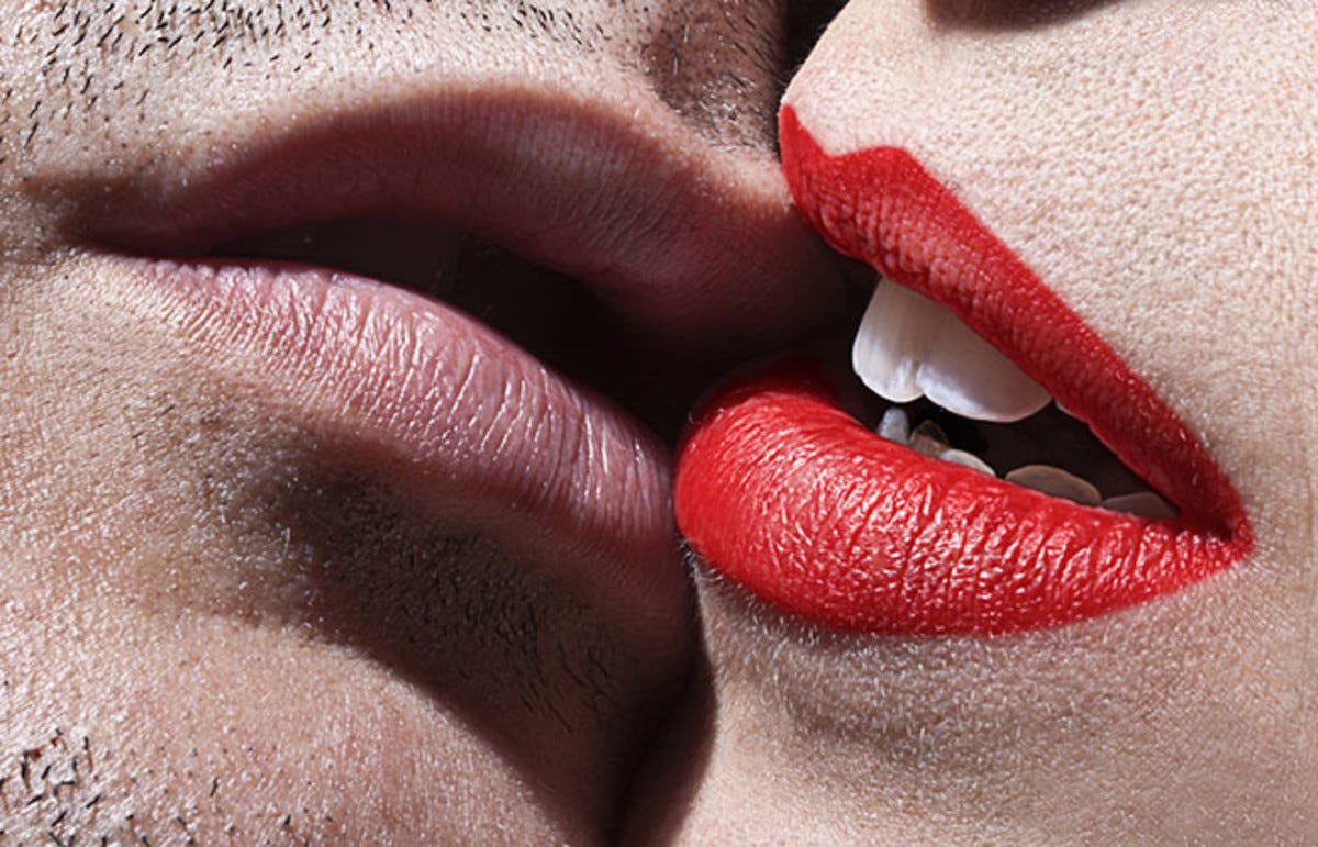 Two sets of lips caressing each other