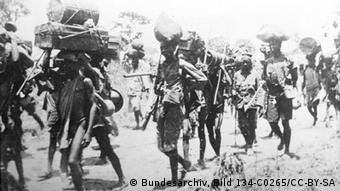 A group of soldiers and bearers on the march