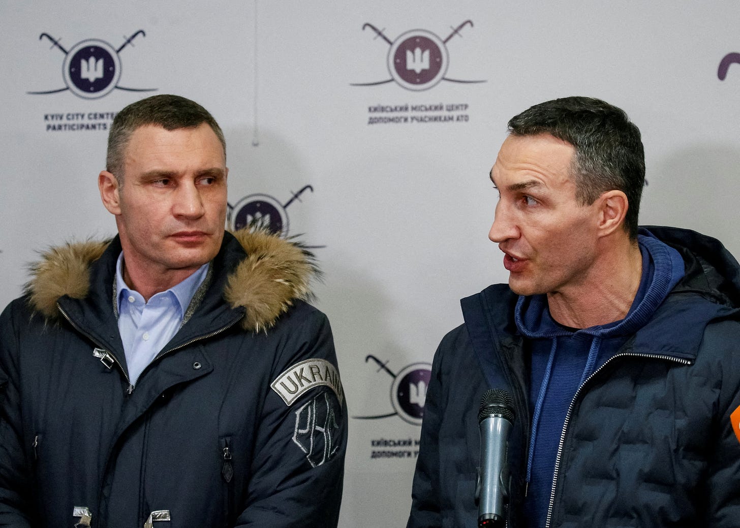 Ukrainian heavyweight boxing world champion Wladimir Klitschko who joined the Ukrainian Territorial Defence Forces and his brother, Mayor of Kyiv and former heavyweight boxing champion Vitaly Klitschko, speak with journalists during the opening of the first Ukrainian Territorial Defence Forces recruitment centre in central Kyiv, Ukraine, February 2, 2022. REUTERS/Gleb Garanich/File Photo