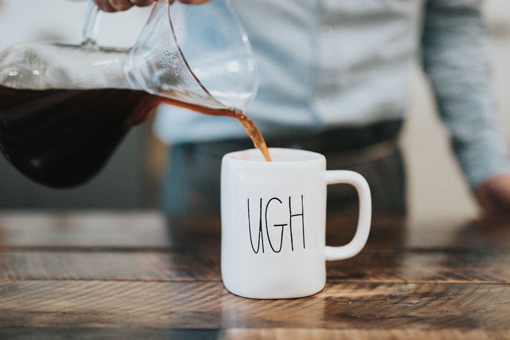 a mug of coffee with "ugh"​ written on the side