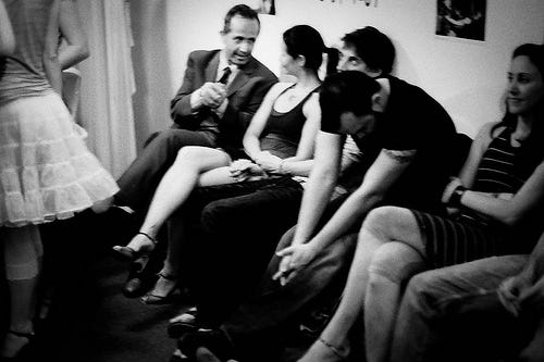 A goup of people sitting on a sofa and discussing