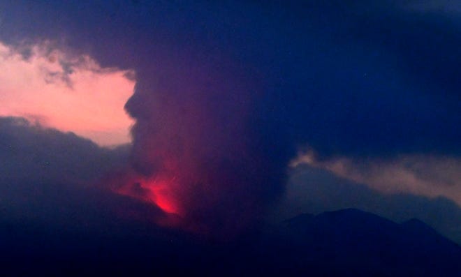 This long exposure image shows the eruption of volcano Sakurajima Sunday night, July 24, 2022, in the view from Tarumizu city, Japan's southern prefecture of Kagoshima.