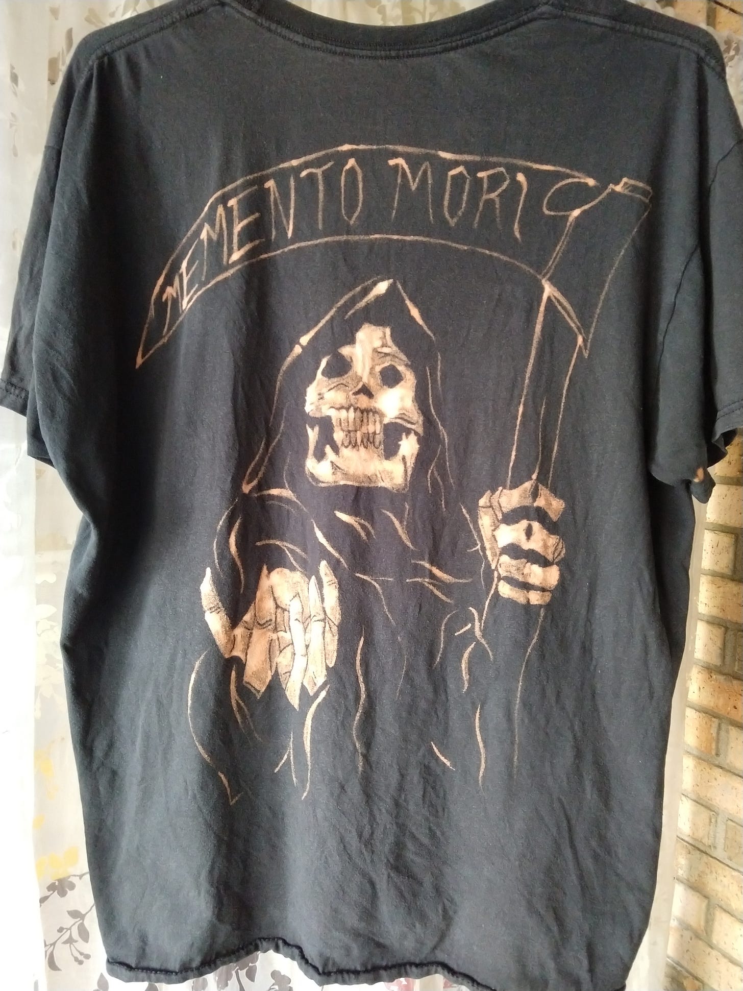 Grim Reaper with "Memento Mori" on the scythe