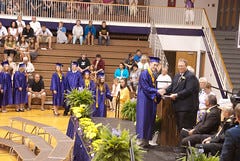 Andrew getting his diploma from his Dad!