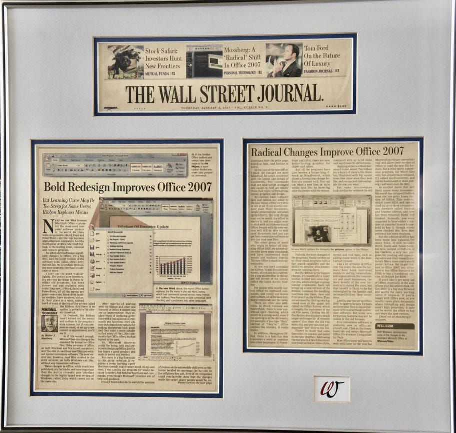 Three sections of a newspaper review cut out and framed in a large frame. The headline in "Bold Redesign Improves Office 2007" and features several screen shots in color. From the Wall Street Journal.