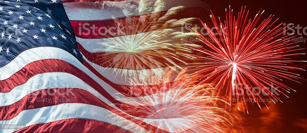 american flag waving for a national holiday with fireworks american flag waving for a national holiday with fireworks Fourth of July Stock Photo