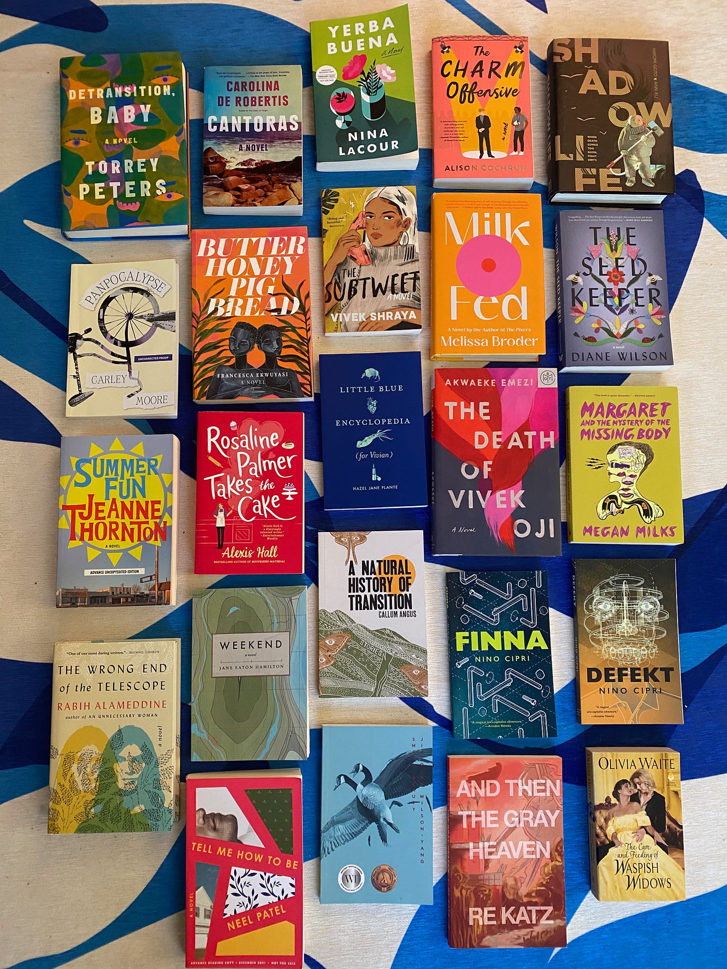 A selection of the books mentioned below, laid out on a blue and white patterned rug.