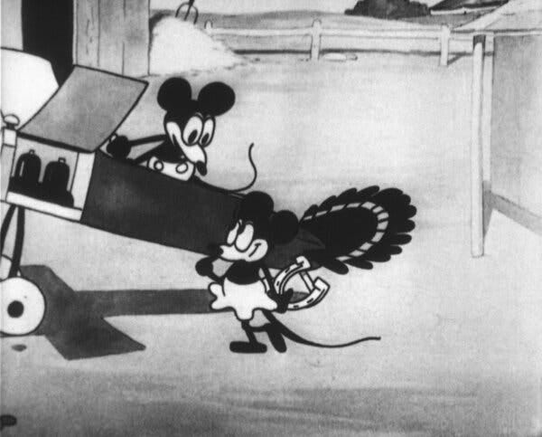 A black-and-white image of the early version of Mickey Mouse standing in a plane and looking at Minnie Mouse.