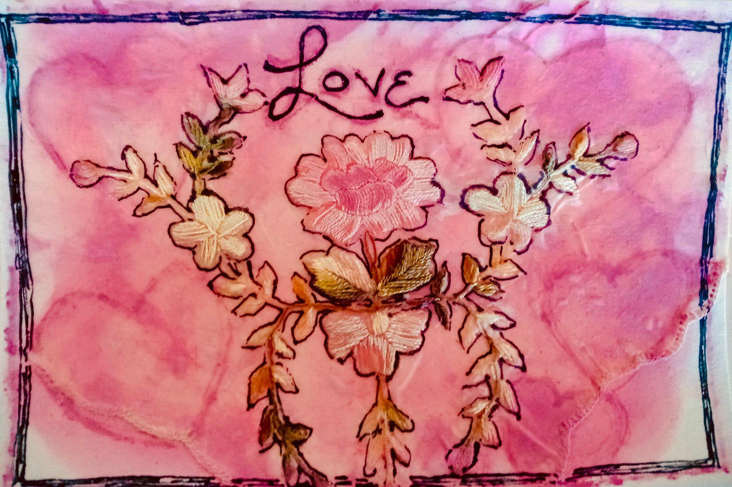 Valentine of pink painted hearts, embroidered flowers, and text "LOVE" at the top