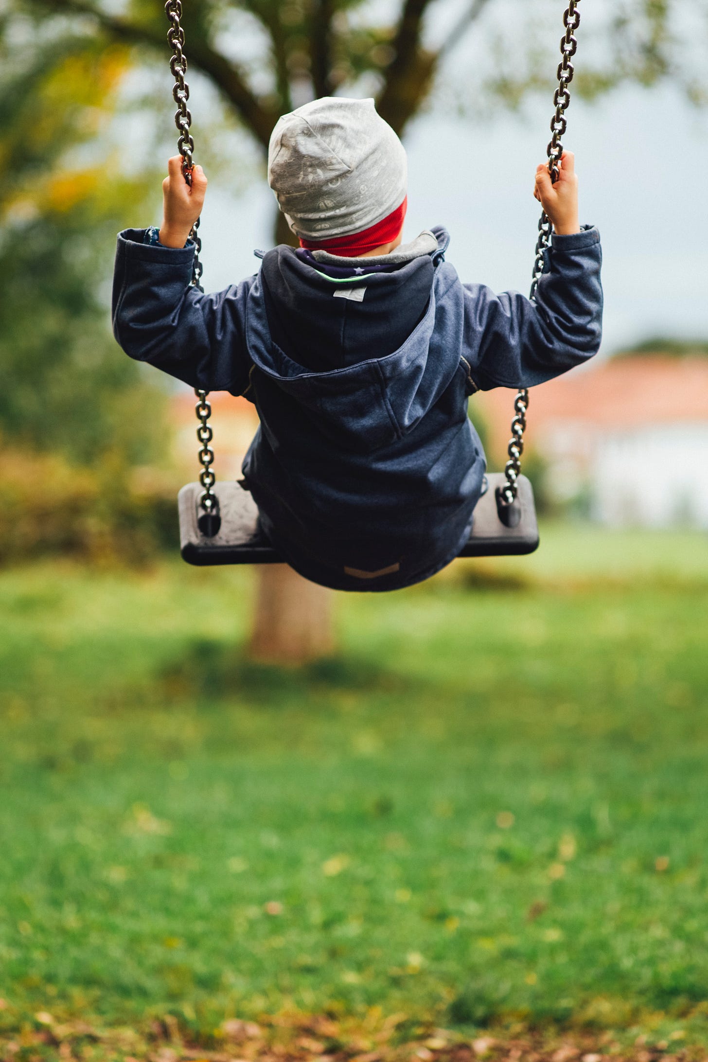 Child on swing rear view