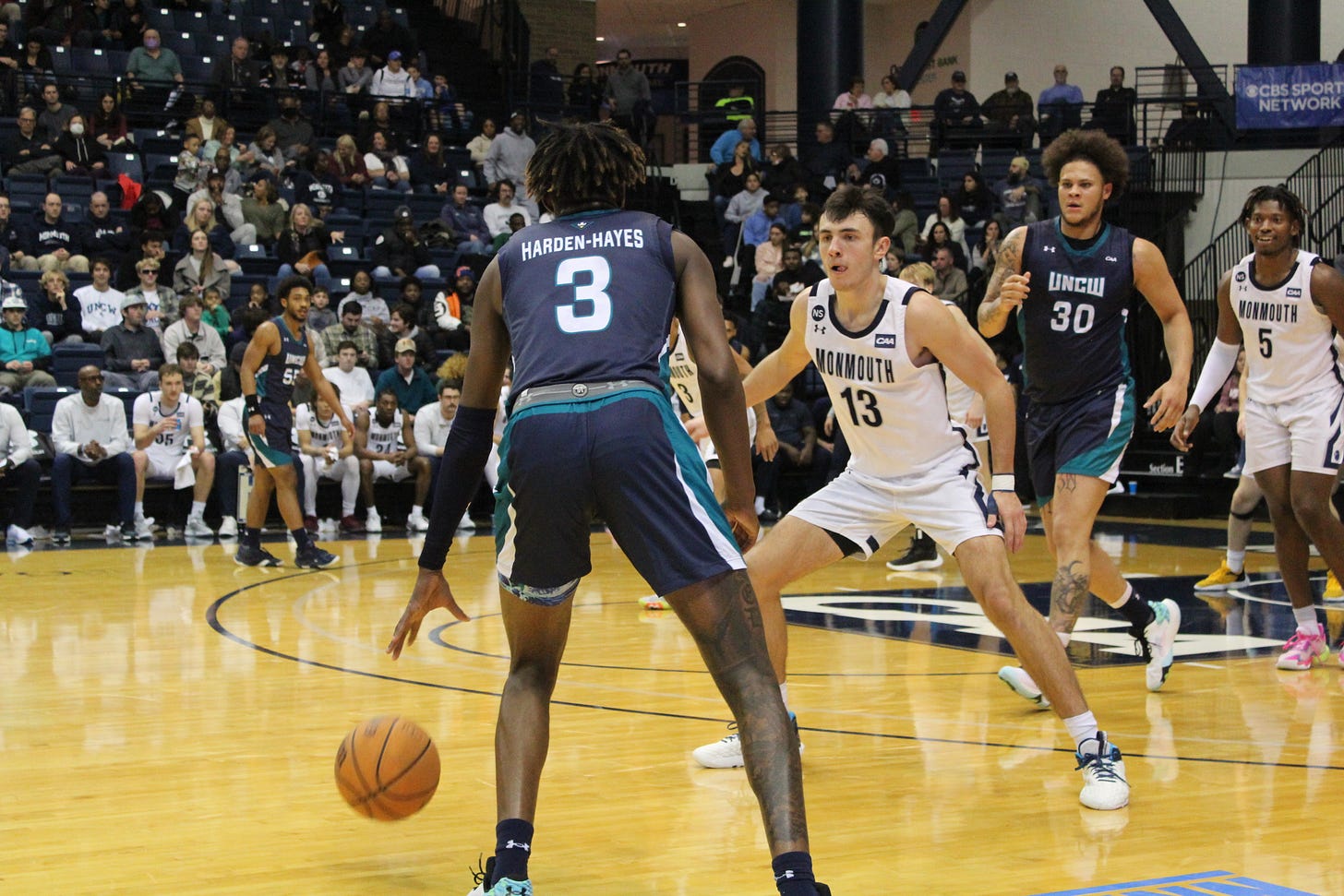 Monmouth’s Jack Collins (13) plays defense as Myles Foster (5) looks on during a game vs. UNC Wilmington on Dec. 28, 2022. (Photo by Adam Zielonka)