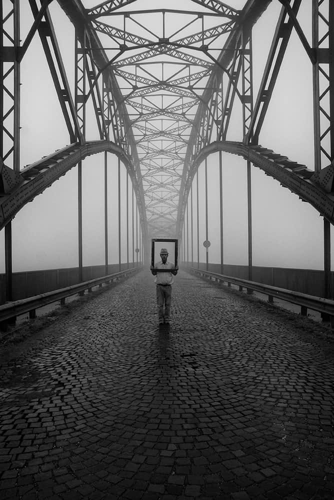 May be a black-and-white image of 1 person and bridge