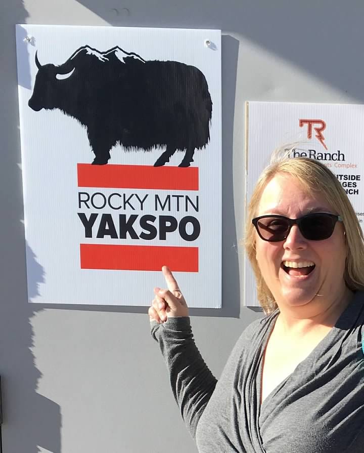 Me, an idiot, pointing at a sign that reads YAKSPO