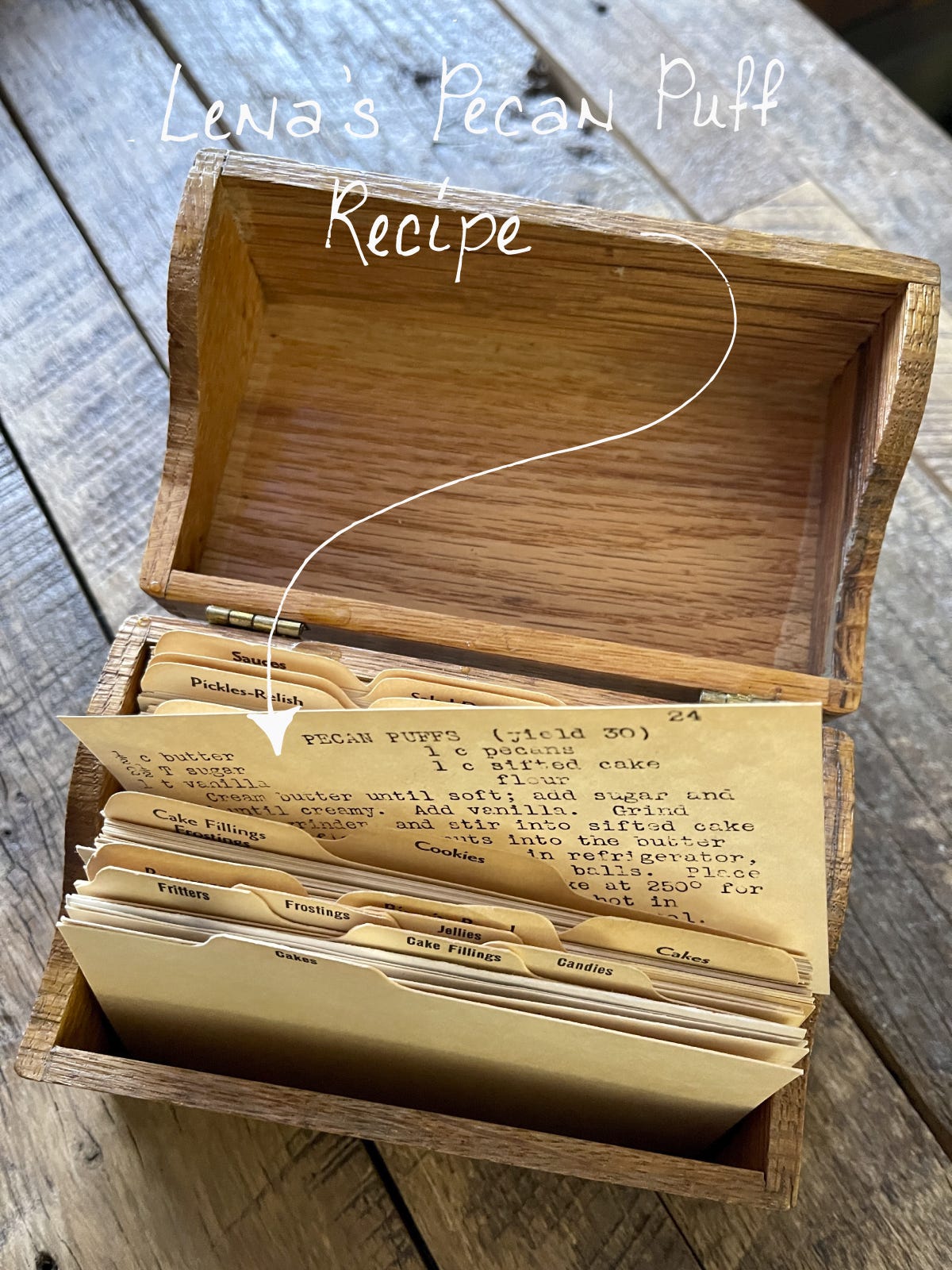 Overhead image of Ruth Haerr's recipe box open with Lena Kelson's Pecan Puff recipe pulled slightly out