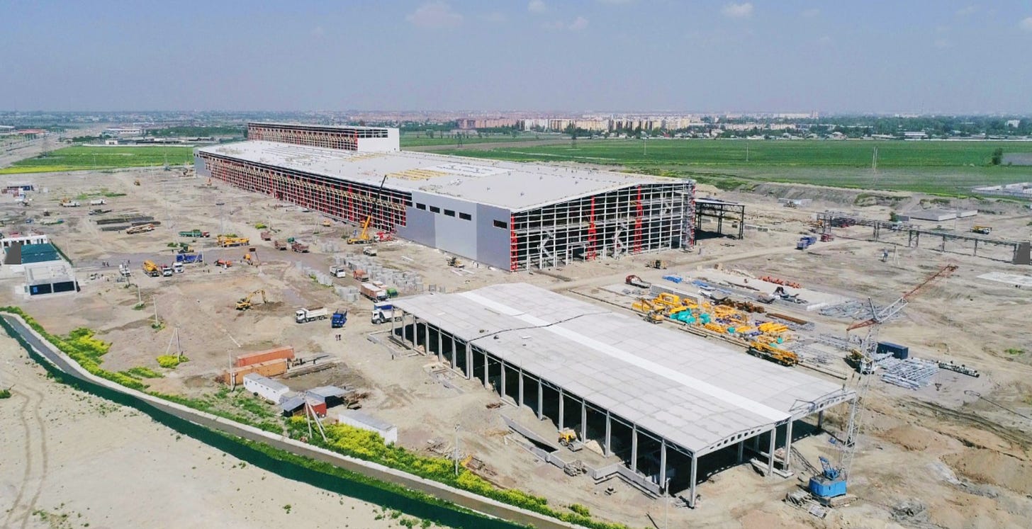 Aerial shot of a large metal manufacturing plant in process of construction.