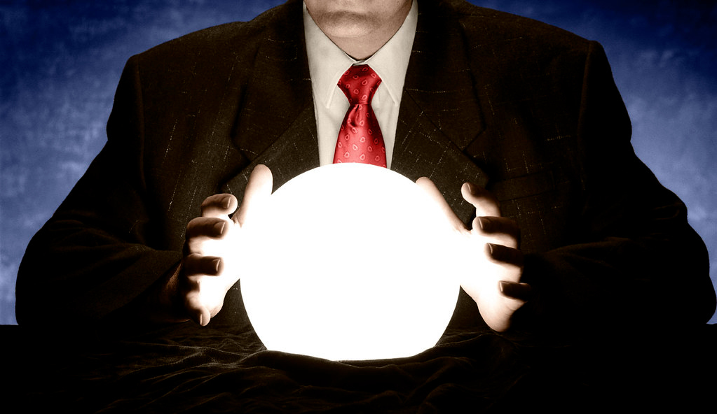 "Businessman Consulting Glowing Crystal Ball" by InfoWire.dk is marked with Public Domain Mark 1.0.