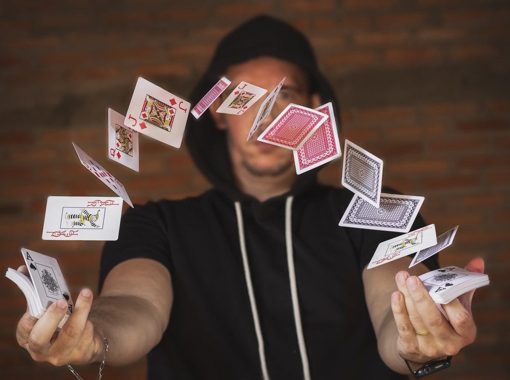 woman in black and white crew neck t-shirt holding playing cards