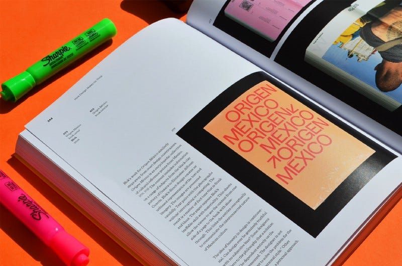 A brightly coloured design book on an orange table.