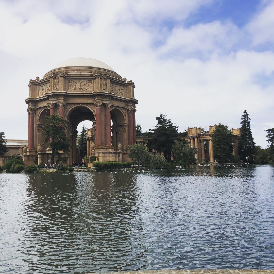A photo of San Francisco's Palace of the Fine Arts and the pond in front of it.
