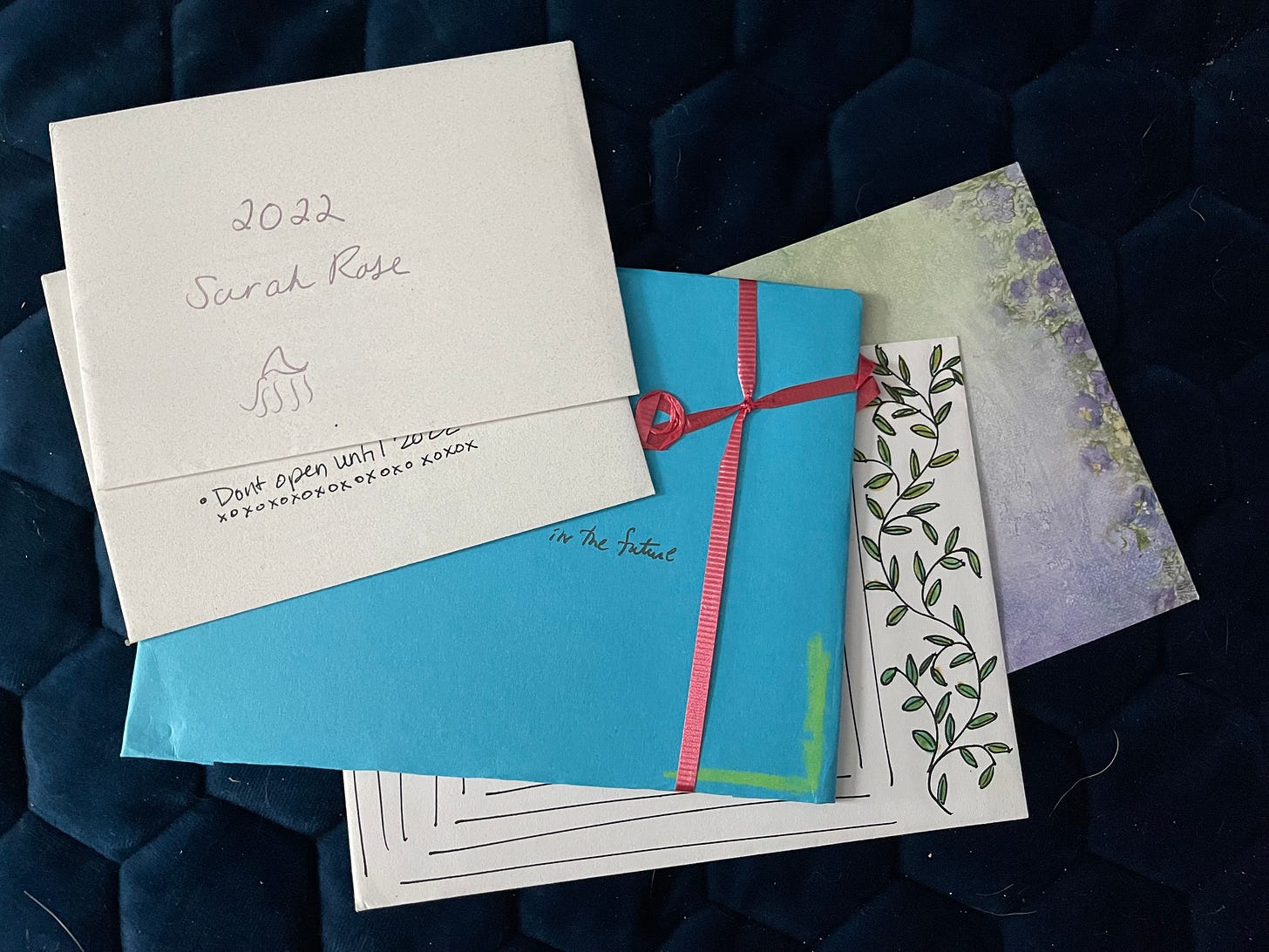 Several cards in envelopes, the top which reads: 2022 Sarah Rose.
