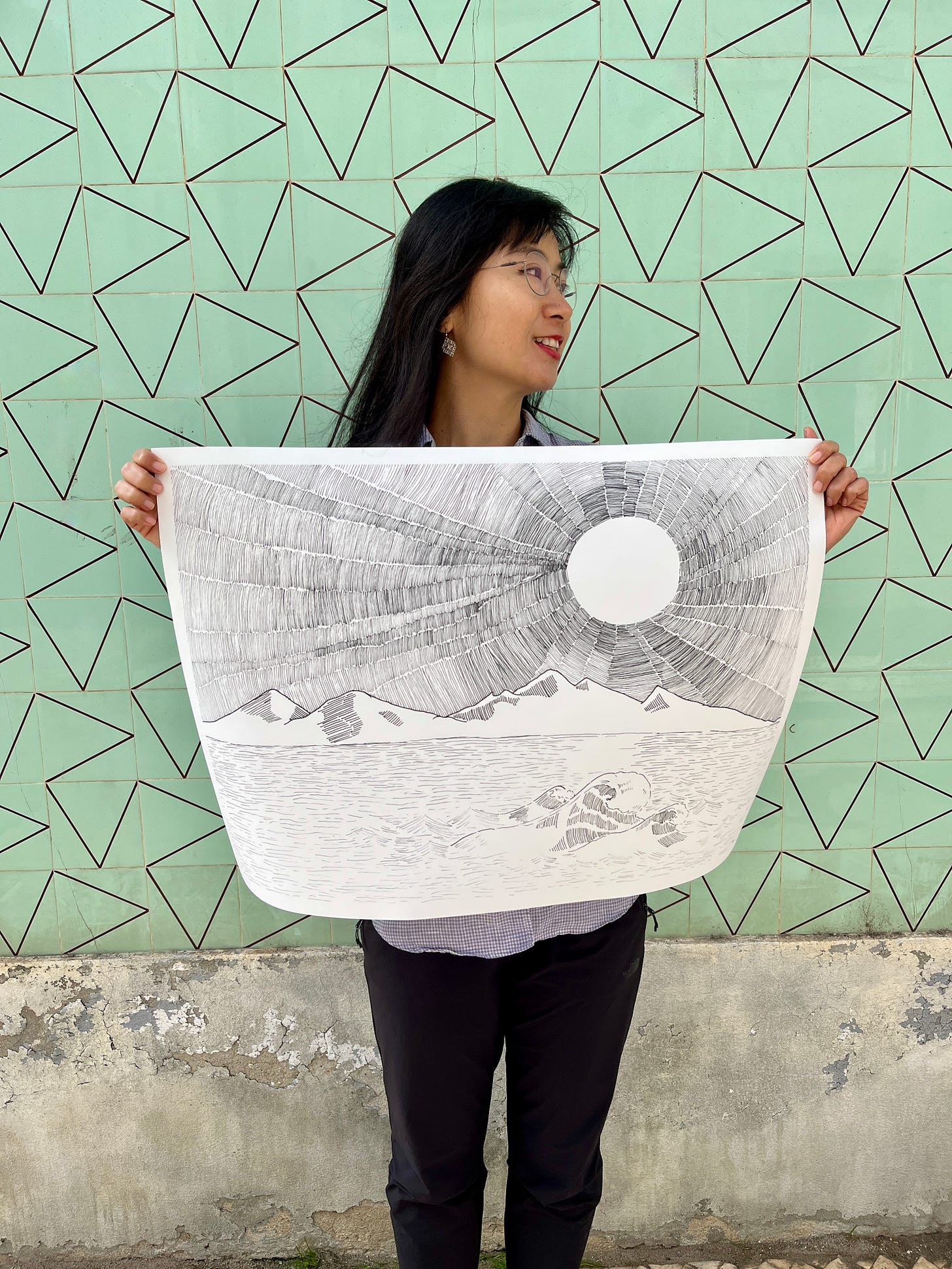 image: photo of an artist holding up her line drawing artwork, In Its Place