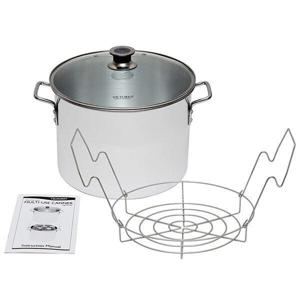 A steam canning pot with glass lid, stainless steel canning rack, and manual