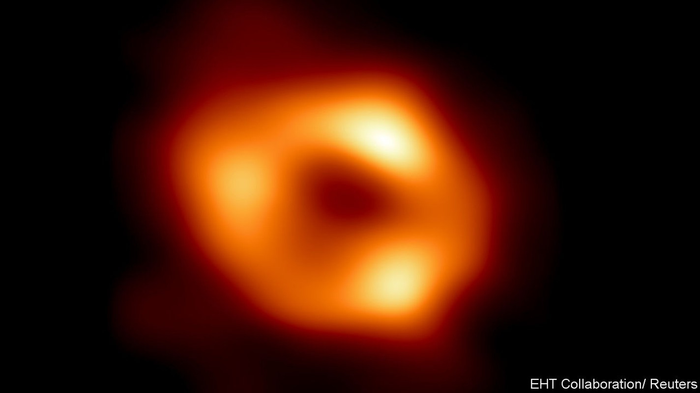 This is the first image of Sagittarius A* (or Sgr A* for short), the supermassive black hole at the center of our galaxy. It was captured by the Event Horizon Telescope (EHT), an array which linked together radio observatories across the planet to form a single "Earth-sized" virtual telescope. The new view captures light bent by the powerful gravity of the black hole, which is four million times more massive than our Sun. EHT Collaboration/National Science Foundation/Handout via REUTERS