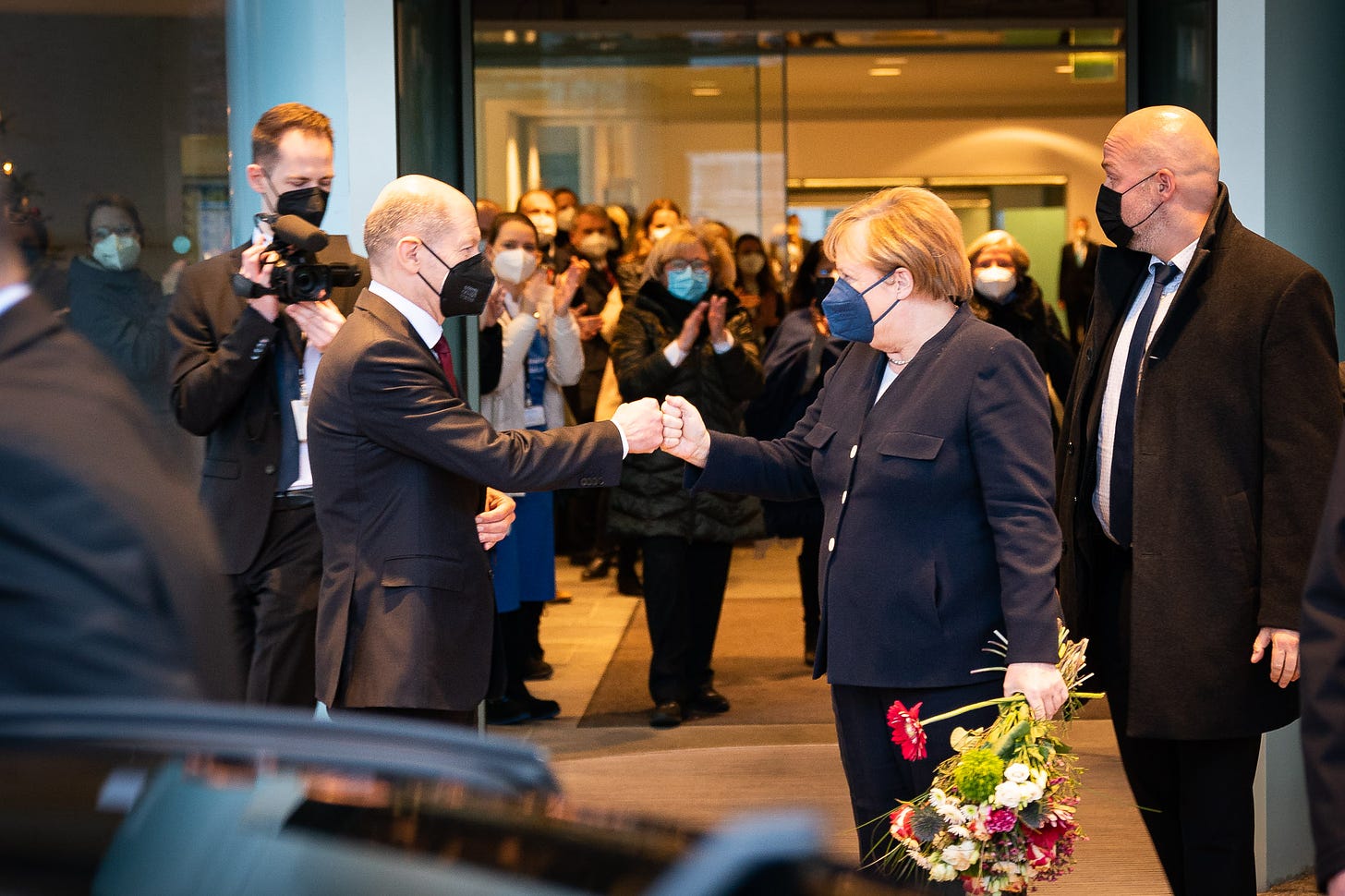 New German Chancellor Olaf Scholz (left) bidding farewell to former chancellor Angela Merkel on December 8, 2021. (Image: Twitter/@RegSprecher)