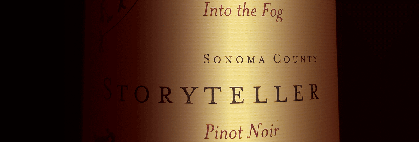 Modified wine label. Gold, with red lettering and black background. Main title-Storyteller. Subtitles-Into the Fog (top), Sonoma County (middle), and Pinot Noir (bottom).