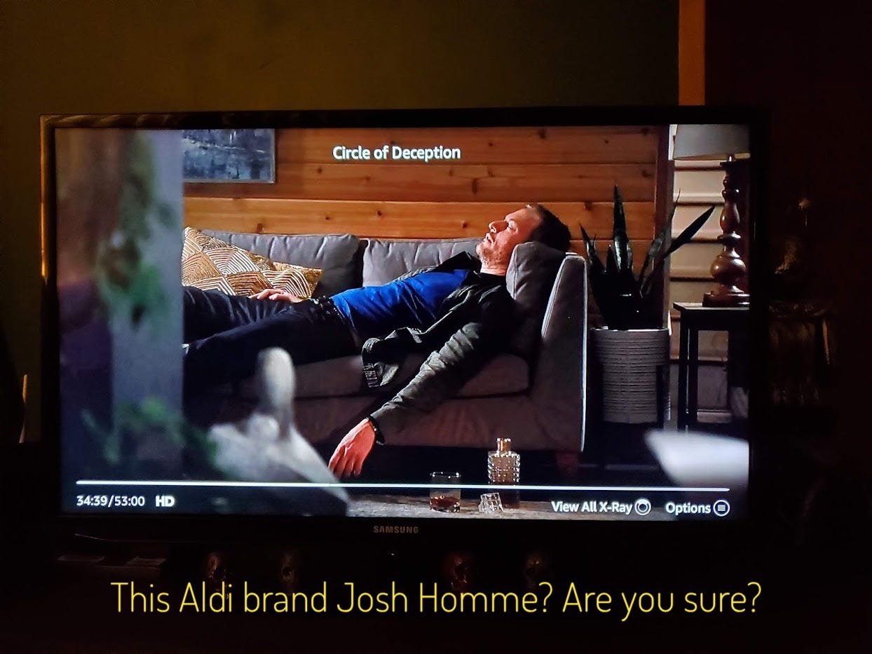 Jim passed out on the couch with a crystal decanter of brown liquor, captioned "this Aldi brand Josh Homme? Are you sure?"