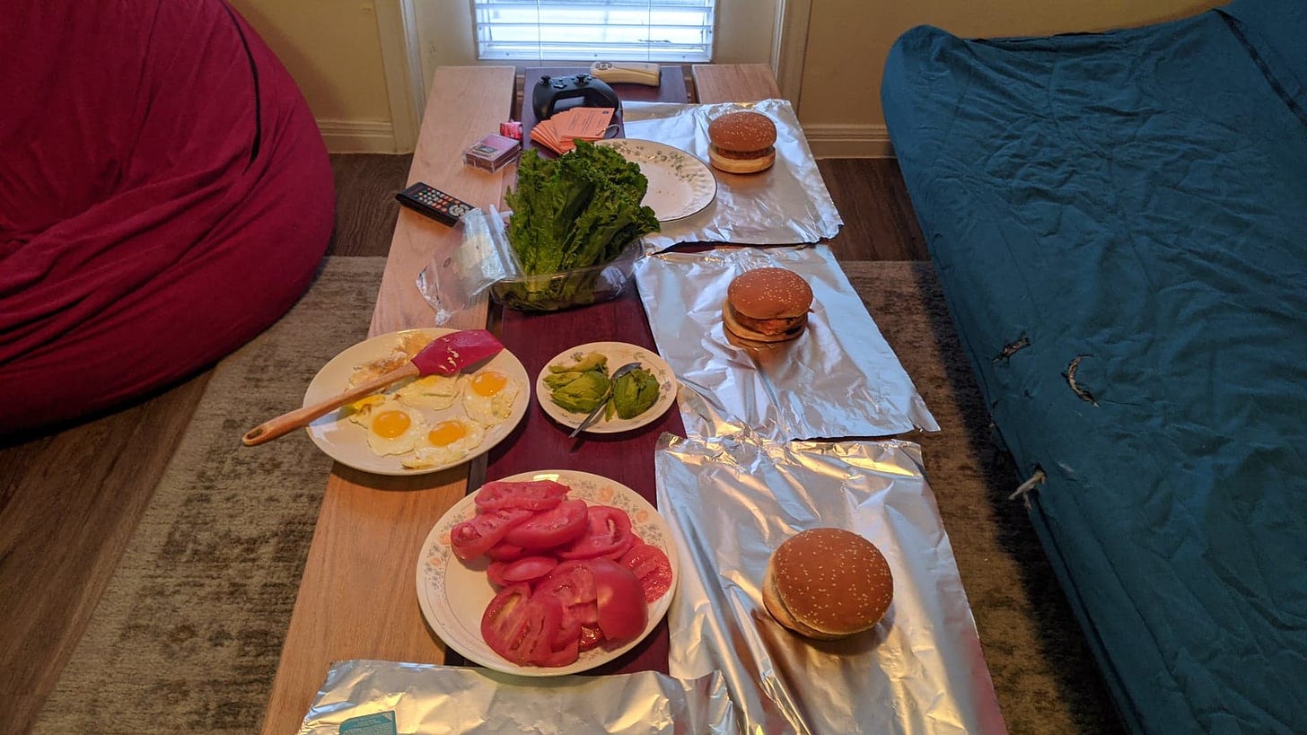 build your own burger set up with eggs lettuce tomatoes and avocado