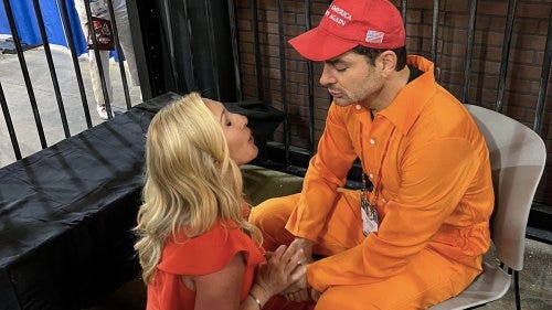Rep. Marjorie Taylor Greene prays with a man dressed as a jailed Jan 6 rioter last Friday at CPAC
