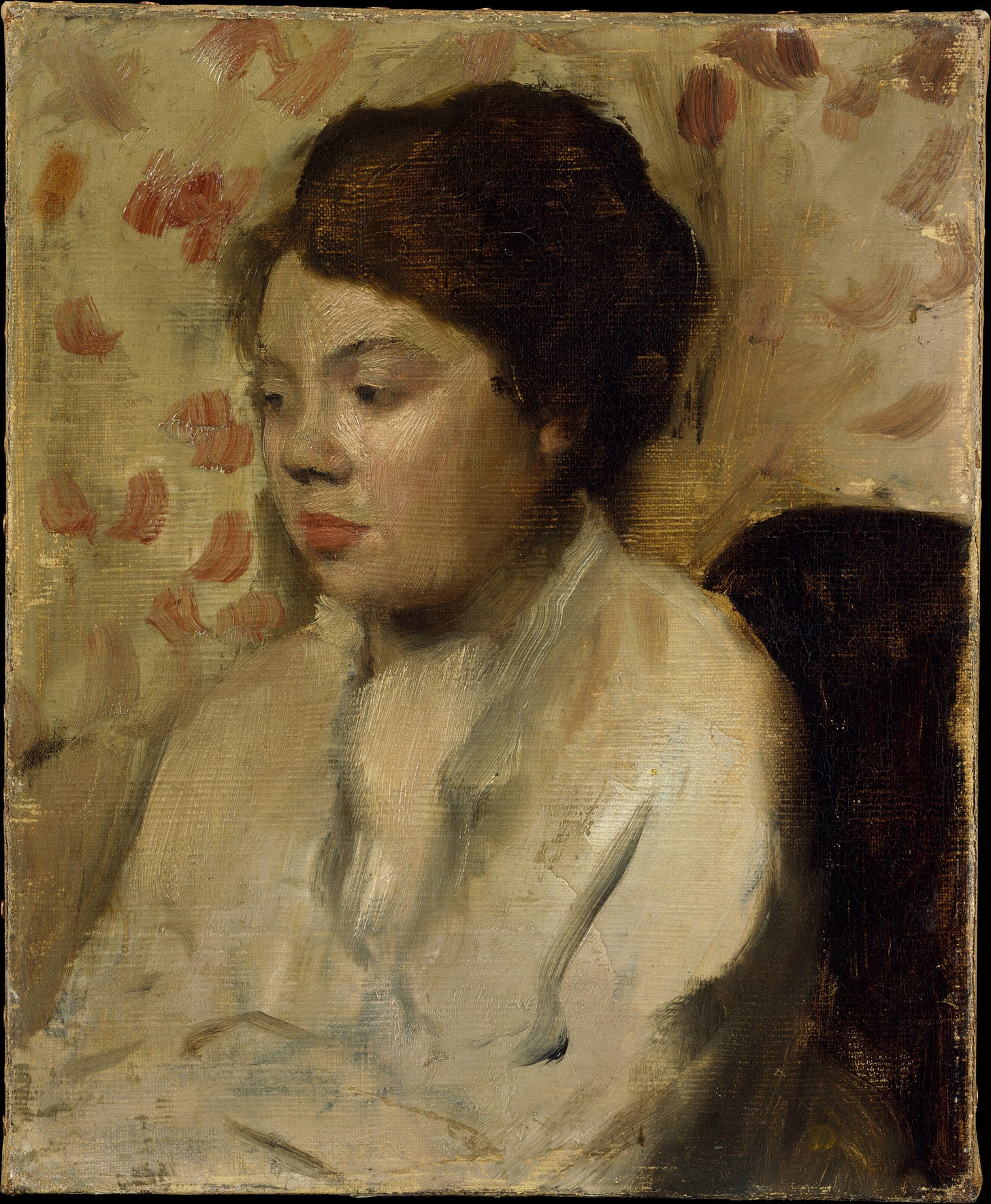 A portrait of a young woman with dark hair sitting. 