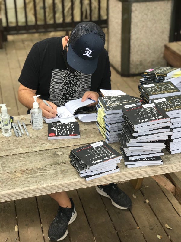 photo of Austin Kleon signing books at bookpeople