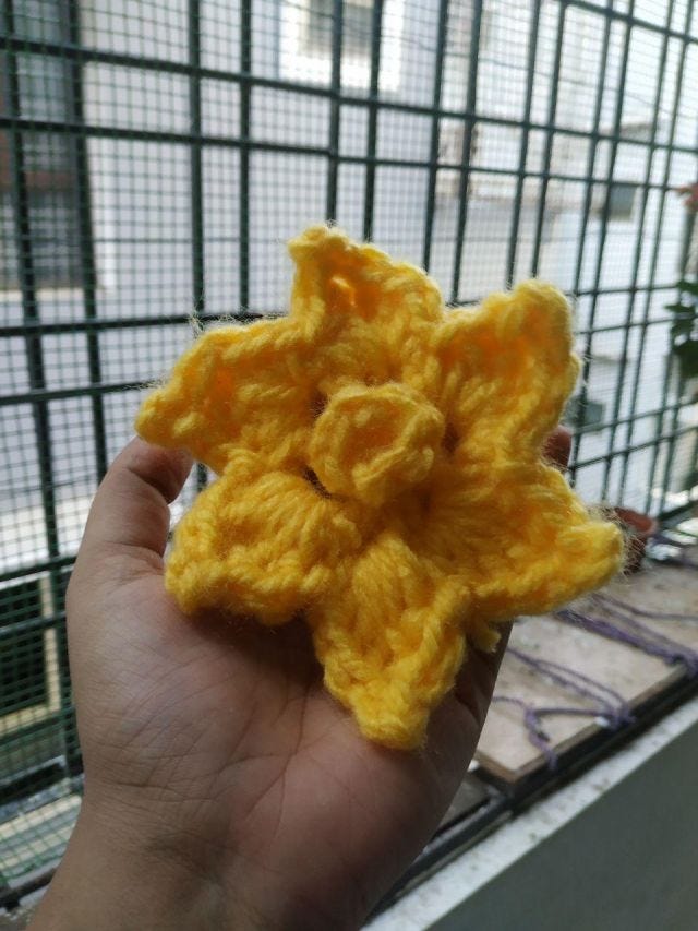 A crocheted yellow daffodil.