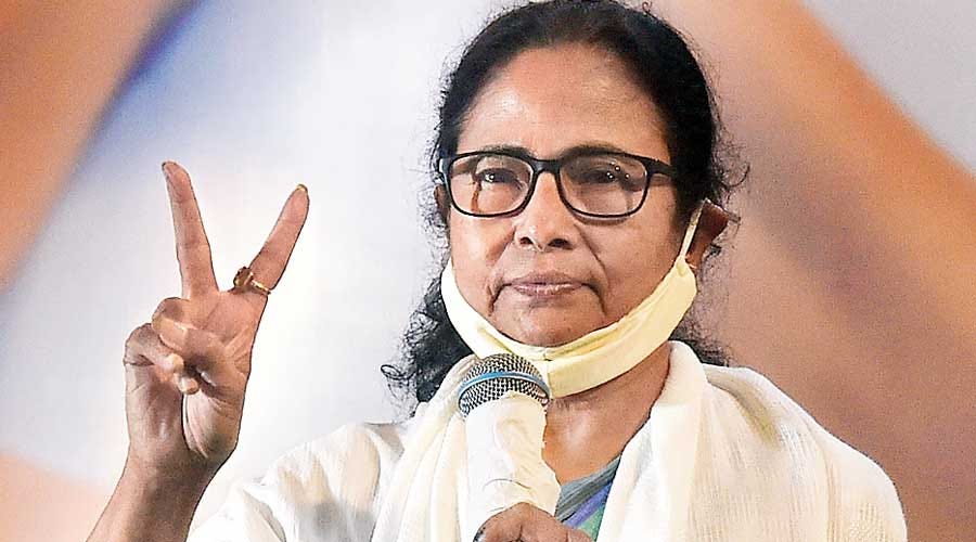 Mamata Banerjee flashes the victory sign in Calcutta  on Sunday.