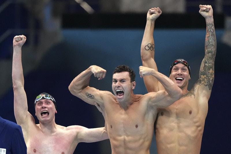 United States men's 4x100m freestyle relay team Bowen Beck, Blake Pieroni, and Caeleb Dressel celebrate after winning the gold medal at the 2020 Summer Olympics, Monday, July 26, 2021, in Tokyo, Japan. (AP Photo/Matthias Schrader)